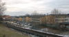 Området sett från nordväst. Parkeringsplatserna ligger som ett band utmed tunnelbanespåret. 
SAK02075_ Stockholm, Skärholmen Lerholmen mm, från nordväst