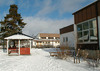 Skärholmen, Granholmen 1, Ekholmsvägen 194-196.

Vy över skolgården från söder, klassrumsbyggnaden till höger, gymnastikbyggnaden i fonden.  