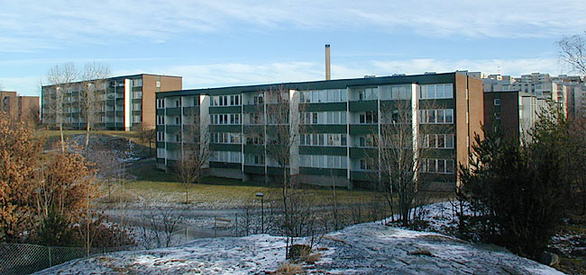 Vårberg, Fjärdholmen 1, Vårholmsbackarna 50-90.

Balkongfasaderna domineras av den gröna korrugerade plåten och de stora fönsterytorna. Vy från sydväst. 