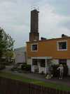 Bakom radhuslängas syns skorstenen till den kombinerade tvättstugan och värmecentralen.