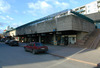 Skärholmen, Måsholmen 12, del av, Ekholmsvägen.

Butiksstråket mot V. I bakgrunden daghemmets utskjutande komplementbyggnad och fd. polisstation.