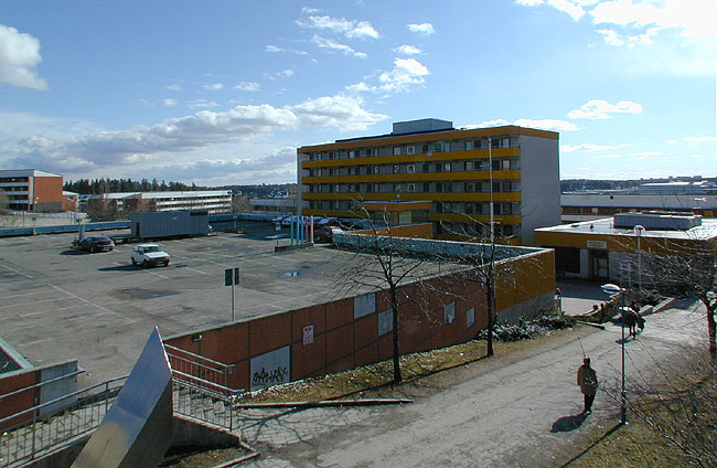 Parkeringsdäck på centrumbyggnadens tak. 

SAK07018 Sthlm, Hjulsta, Centrum, Stafsinge 1, Lästringe 4, Hjulsta Torg 1-3, från nord