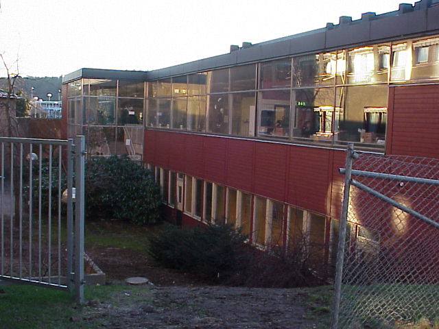 Föreningshusets stora uppglasade fasad som vetter in mot ett outnyttjat gårdsrum. 