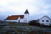Från norr, med församlingshemmet till höger och framför kyrkan bårhus/ekonomibyggnad. 