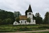 Hångsdala kyrka och kyrkogård, i förgrundens hage står en liljesten. Neg.nr. 04/312:03. JPG.
