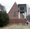 Gavlarna är höga, takfallet är brant. På den västra gaveln sitter en väggskulptur i koppar, "Den treenige guden" av konstnären Bertil Lundgren. Den invigdes 1972. 
