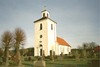 Gällinge kyrka med omgivande kyrkogård sedd från sydväst.