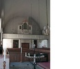 Interiörbild av kyrkorummet/salen sedd från koret med bänkrader och orgelläktare. 