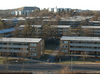 Väster om Skärholmens centrum ligger i den flacka dalgången ett stort bostadsområde med lamellhus med loftgångar.
