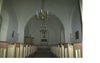 Kyrkorummet med altargång och bänkinredning. 