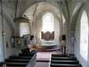 Altartavlan är nytillverkad på 2000-talet. I koret sitter ett rekonstruerat medeltidsfönster 
av kalksten. Den fasta inredningen härrör från återuppbyggnaden efter 1813 års brand. 
