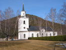 Multrå kyrka med omgivande kyrkogård, vy från sydväst. 