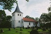 Åsbräcka kyrka med omgivande kyrkogård sedd från SV.