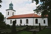 Fuxerna kyrka med omgivande kyrkogård sedd från SÖ.