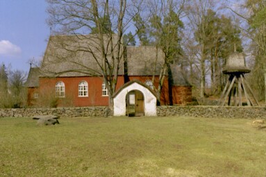 Kyrkan med stiglucka och klockstapel. Kyrkan stod i Kinnarumma innan den flyttades hit till Ramnaparken.