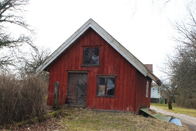 Stuga belägen mellan bostadshuset och ladugården