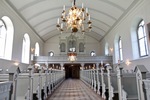 Kyrkorummet mot väster med orgelläktaren och orgelfasaden med drag av nygotik.