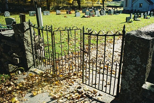 Tredelad smidesgrind i norra kyrkogårdsmuren vid Grönahögs kyrka, från NV.