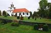 Tostareds kyrka med omgivande kyrkogård, från SÖ.