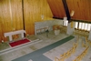 Sjöbo kyrka sedd mot altaret och dopfunten från orgelläktaren.