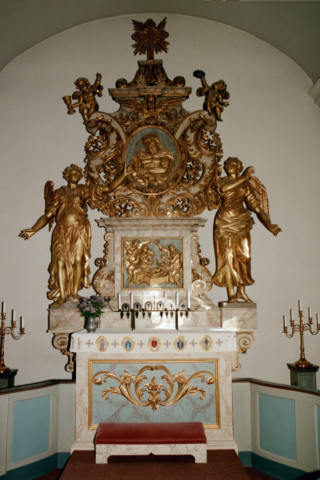 Frösö kyrka, interiör, kyrkorummet, Altaret.

Den ljust marmorerade och förgyllda altaruppsatsen i barockstil, köpt 1708, kan tillskrivas Daniel Kortz från Stockholm. 